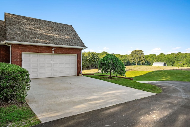 garage featuring concrete driveway