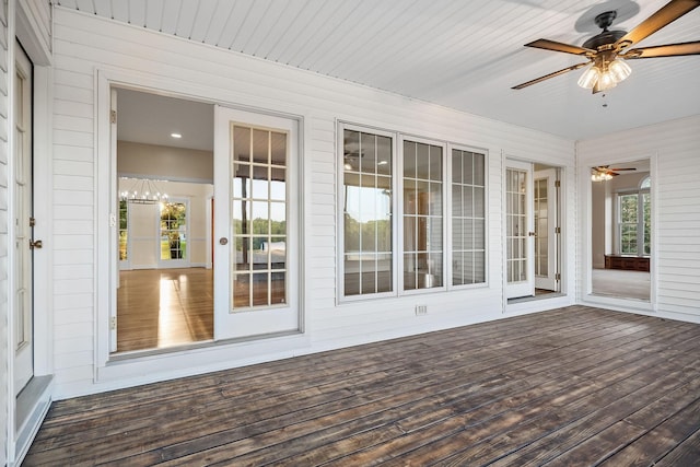 unfurnished sunroom with a ceiling fan