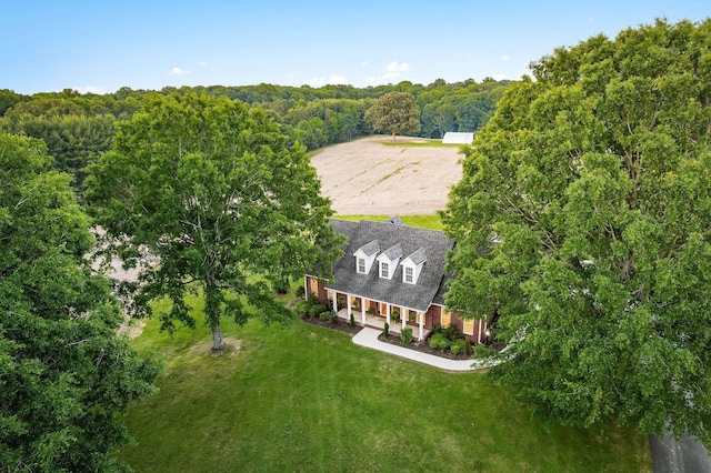 bird's eye view with a wooded view