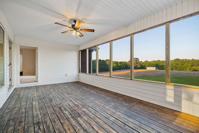 unfurnished sunroom with a ceiling fan