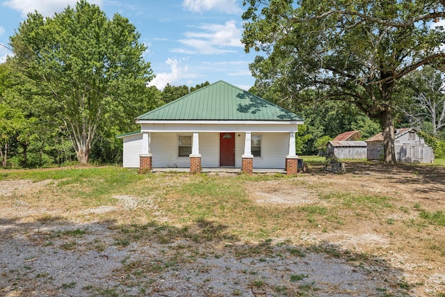 exterior space with a porch and a shed