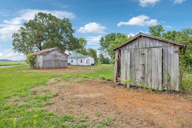 view of yard featuring a rural view and a storage unit