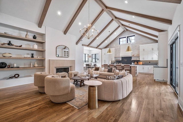 living room with hardwood / wood-style floors, beam ceiling, high vaulted ceiling, and a chandelier