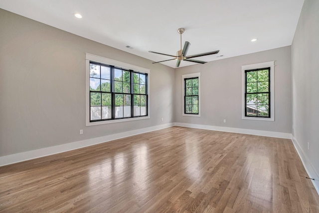 empty room with ceiling fan and light wood-type flooring