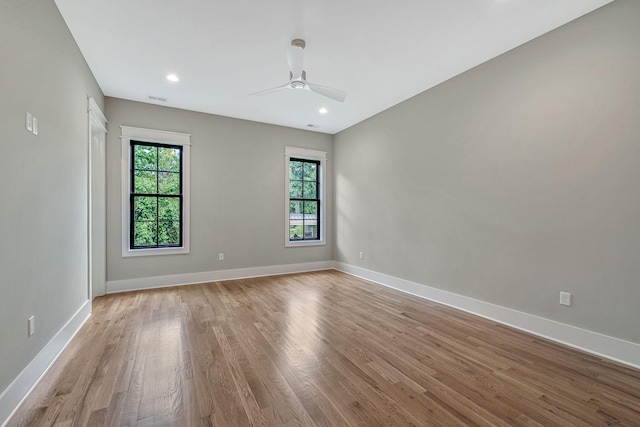 unfurnished room with ceiling fan and light hardwood / wood-style floors