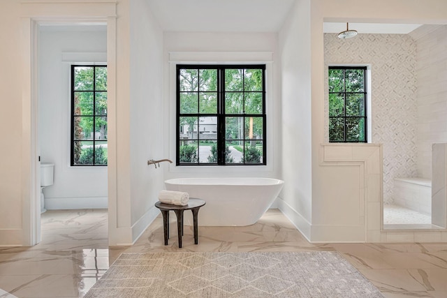 bathroom featuring shower with separate bathtub