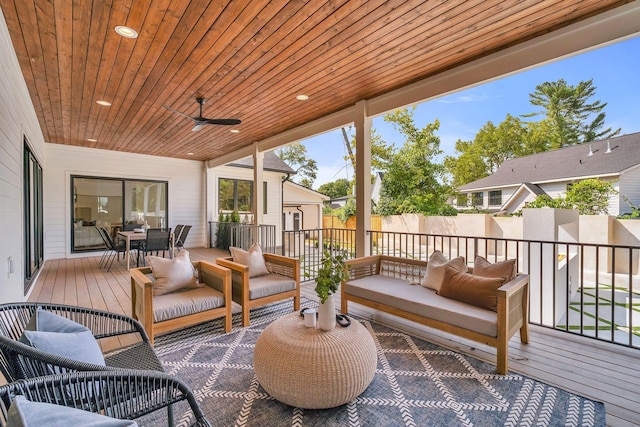 sunroom with ceiling fan and wooden ceiling