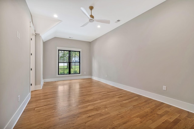 spare room featuring ceiling fan, lofted ceiling, and light hardwood / wood-style floors