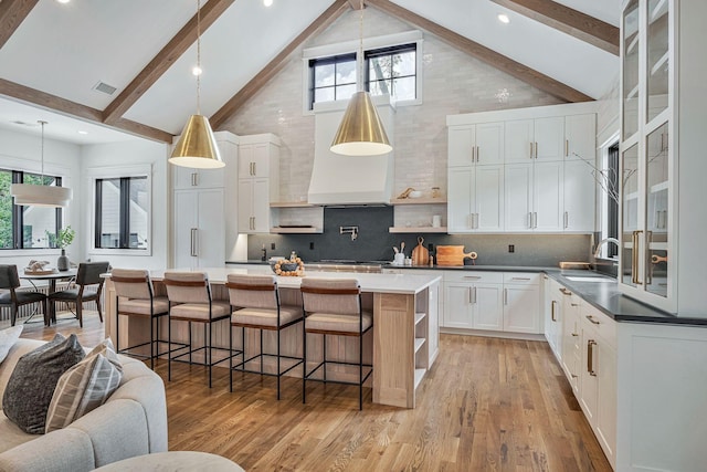 kitchen with tasteful backsplash, white cabinetry, high vaulted ceiling, and beamed ceiling