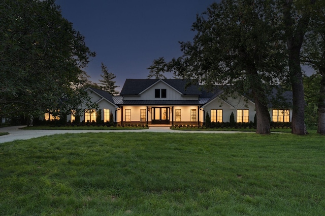 modern farmhouse style home featuring a porch and a yard