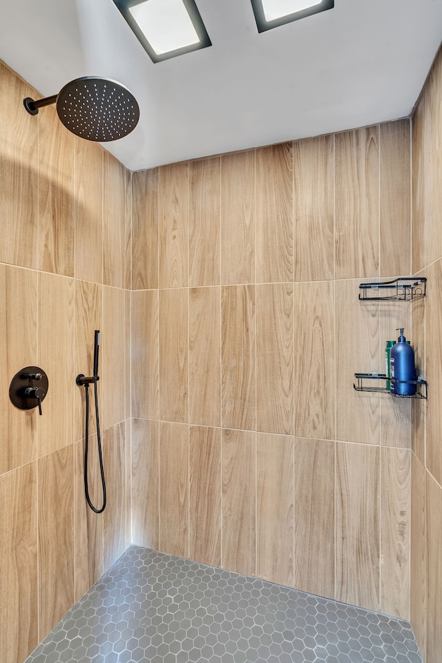 bathroom with walk in shower, tile patterned floors, and wooden walls