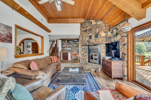 living room featuring a fireplace, ceiling fan, vaulted ceiling with beams, hardwood / wood-style floors, and wood ceiling