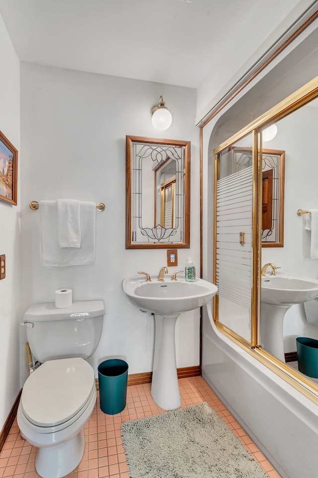 bathroom featuring tile patterned flooring, enclosed tub / shower combo, and toilet