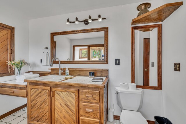 bathroom featuring tile patterned floors, vanity, and toilet