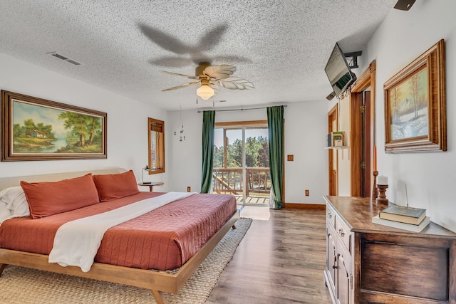 bedroom with hardwood / wood-style flooring, a textured ceiling, access to outside, and ceiling fan