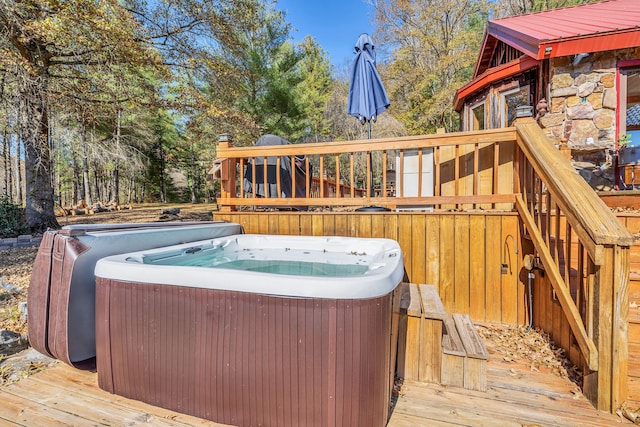 wooden deck with a hot tub