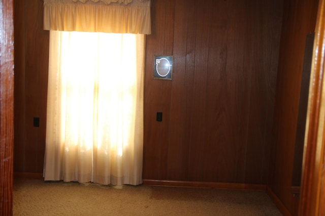 empty room with a wealth of natural light and wooden walls