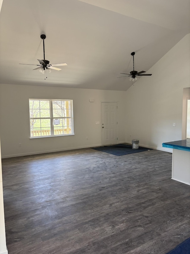 unfurnished living room with dark wood-style flooring, baseboards, and a ceiling fan