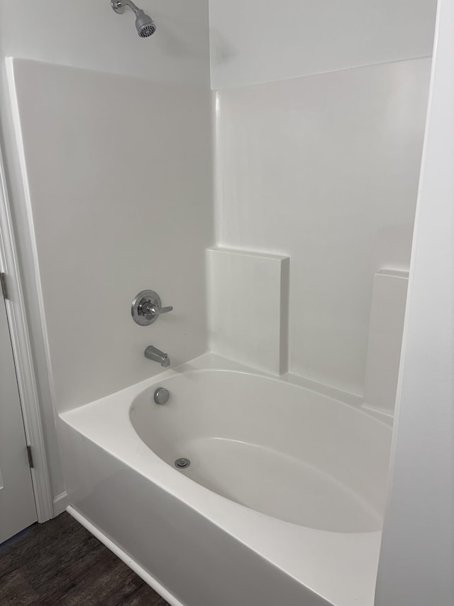 full bath with bathing tub / shower combination and wood finished floors