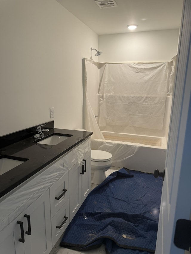 full bathroom featuring vanity, shower / bathtub combination with curtain, and toilet