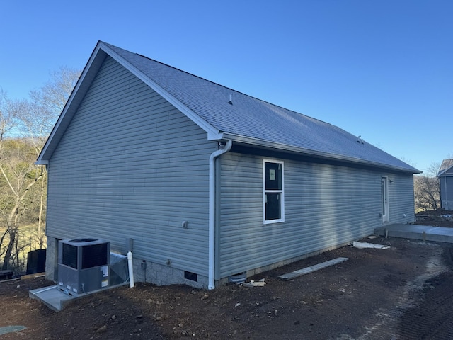 view of side of home with central AC unit