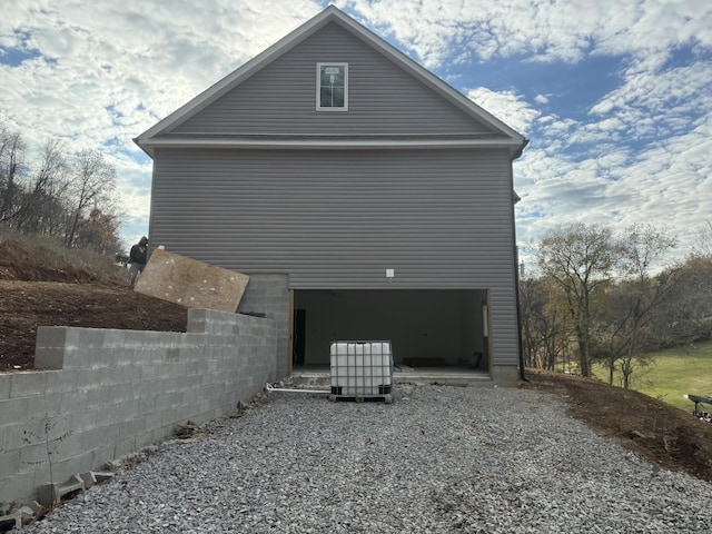 view of side of home featuring a garage