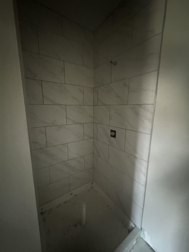 bathroom with tiled shower