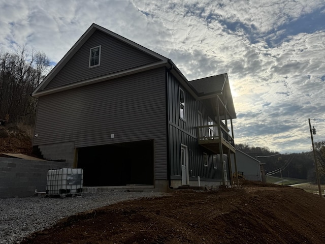 view of side of property with a balcony and a garage