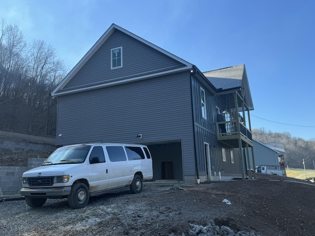 view of property exterior featuring a garage and a balcony