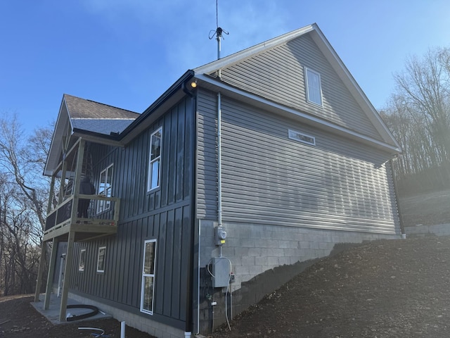 view of side of home with a balcony