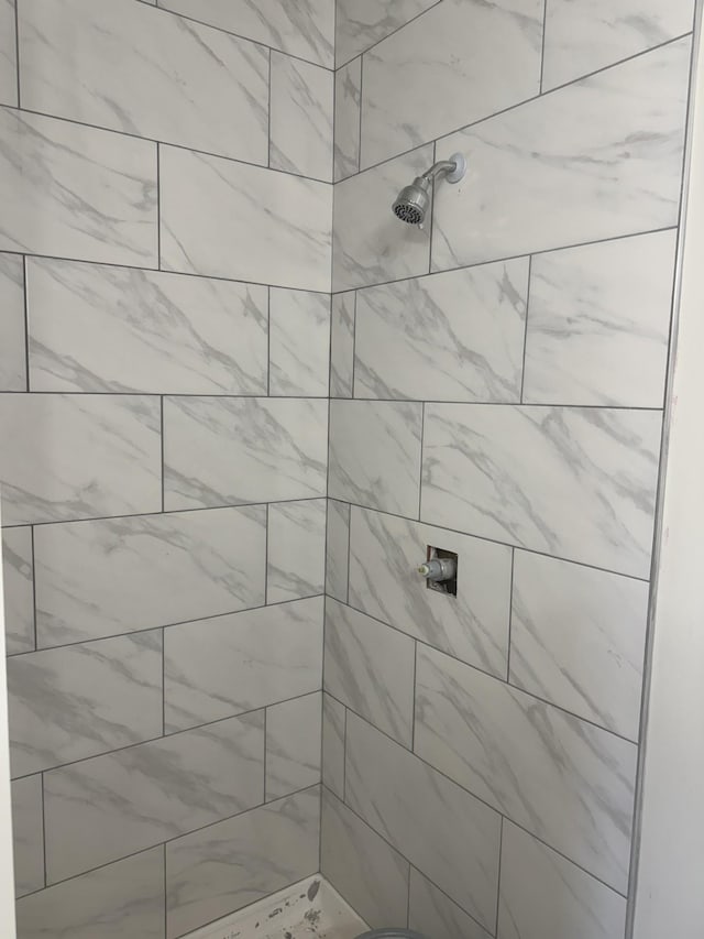 bathroom with a tile shower