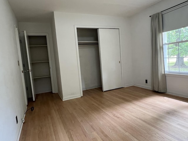 unfurnished bedroom with light hardwood / wood-style floors and a closet