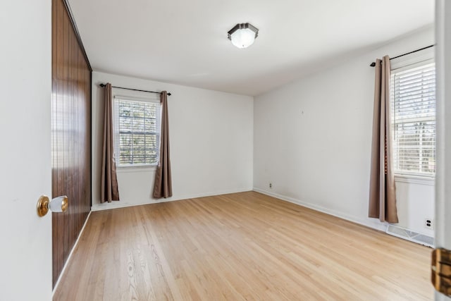 spare room featuring light hardwood / wood-style floors