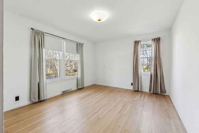 spare room with light wood-type flooring