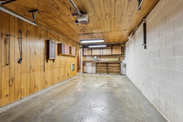 garage with wood ceiling and a garage door opener