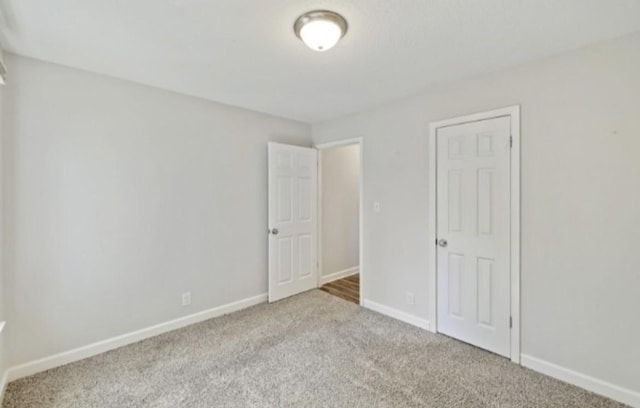 unfurnished bedroom featuring light carpet