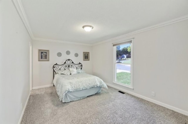 carpeted bedroom with ornamental molding