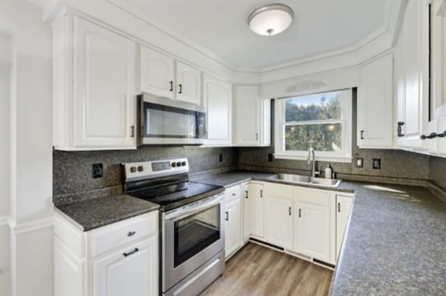 kitchen featuring white cabinetry, sink, tasteful backsplash, and stainless steel appliances