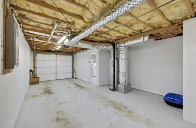 garage with electric panel and water heater