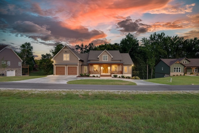 view of front of house with a garage and a yard