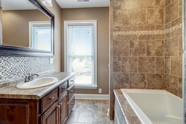 bathroom featuring vanity, tile patterned floors, and tasteful backsplash