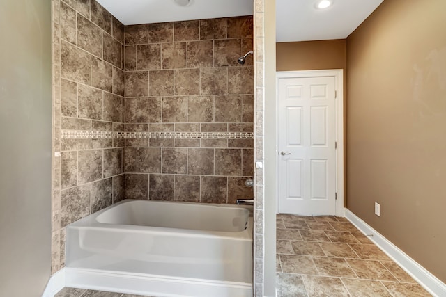 bathroom with tiled shower / bath combo and tile patterned floors