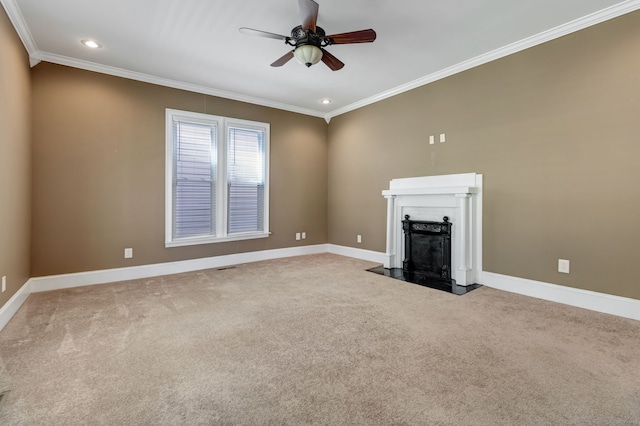 unfurnished living room featuring a premium fireplace, carpet floors, ceiling fan, and crown molding