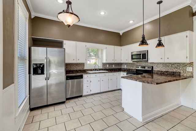 kitchen featuring white cabinetry, stainless steel appliances, backsplash, and pendant lighting