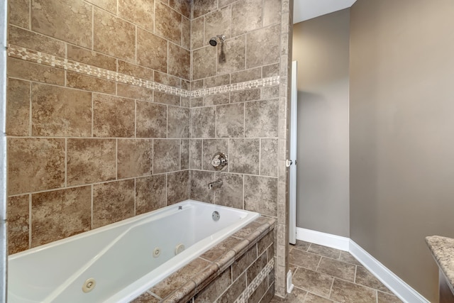 bathroom featuring tiled shower / bath and tile patterned flooring