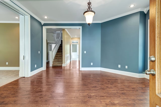 empty room with crown molding and dark hardwood / wood-style flooring