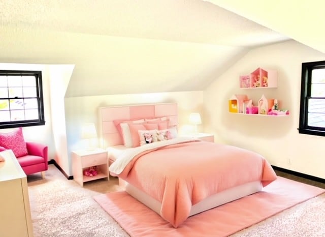 carpeted bedroom featuring vaulted ceiling and multiple windows