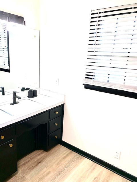 bathroom with hardwood / wood-style floors and vanity