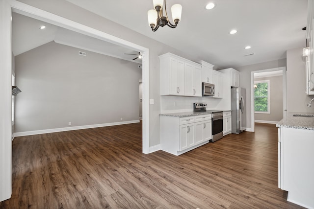 kitchen featuring ceiling fan with notable chandelier, stainless steel appliances, hardwood / wood-style flooring, and white cabinetry