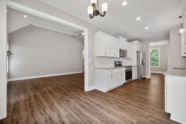 kitchen with stainless steel appliances, light stone countertops, sink, and white cabinets